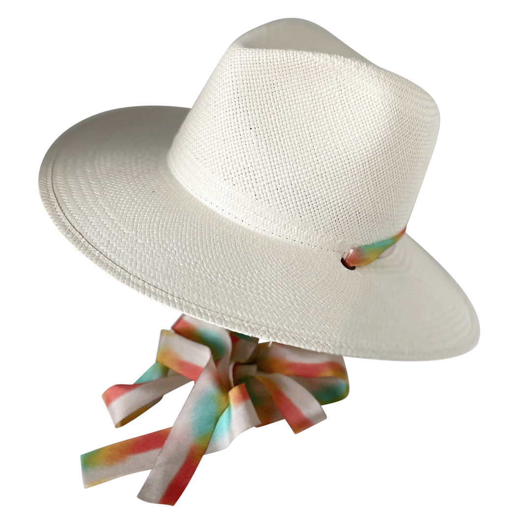 Khia Tullae The Billie white toquilla straw wide-brim hat with multicolor pastel rainbow silk drop-down ribbon, angled product cutout with ribbon detail