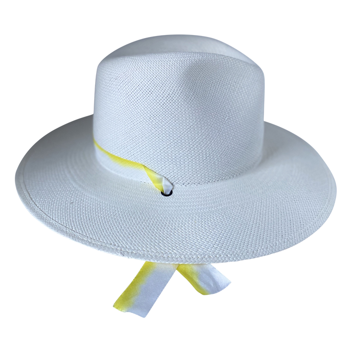 The Siena white toquilla straw wide-brim hat with yellow and white silk drop-down ribbon, left-side product cutout