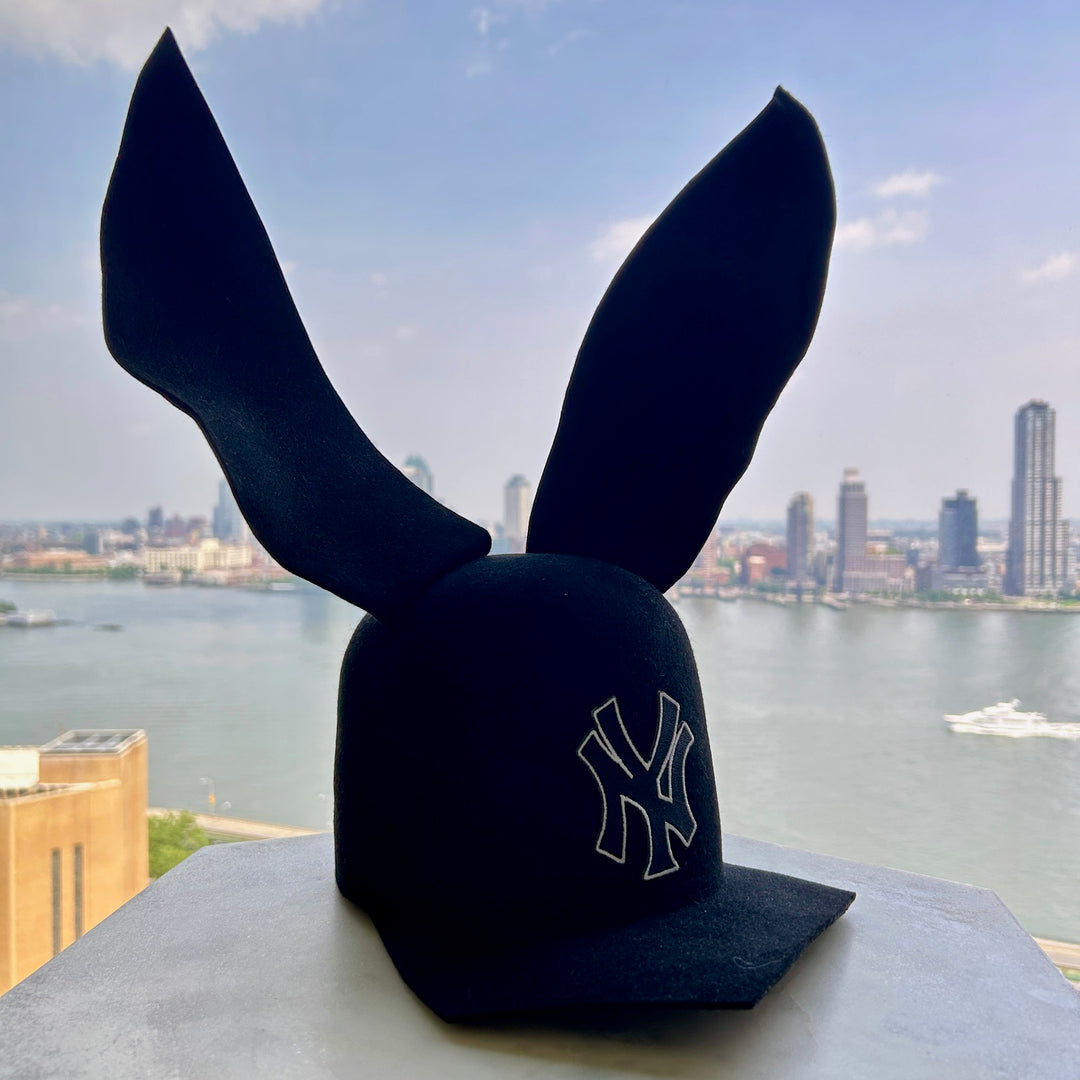 Khia Tullae The 212 Asymmetric Bunny Lid hat in black felt with New York logo and bendable ears, front angled right view