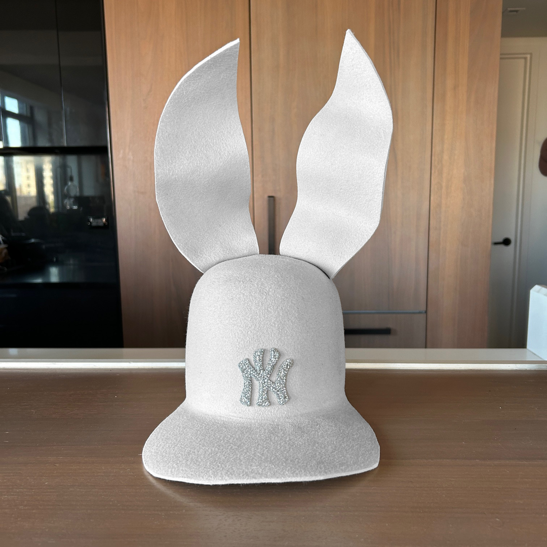 Khia Tullae The 212 Embellished Bunny Lid hat in bone felt with NY patch embellished with rhinestones and waved ears, front view