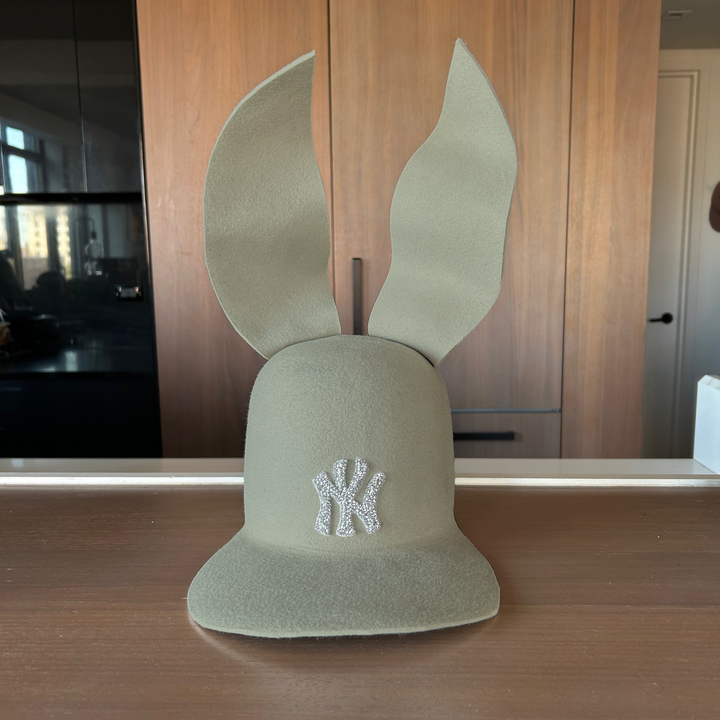 Khia Tullae The 212 Embellished Bunny Lid hat in willow felt with NY patch embellished with rhinestones and waved ears, front view