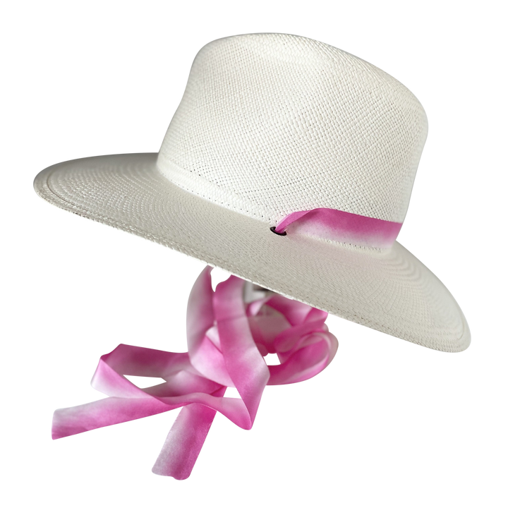 Khia Tullae The Brynn white toquilla straw wide-brim hat with pink and white silk drop-down ribbon, angled product cutout with ribbon detail