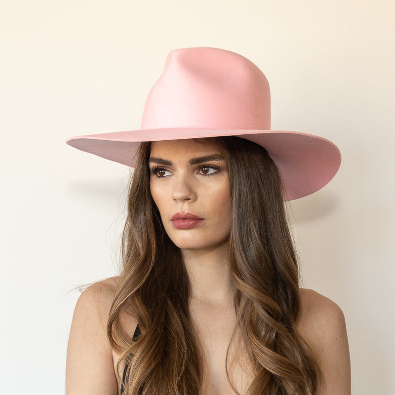Khia Tullae The Lex pink wool wide-brim fedora, angled front view on model