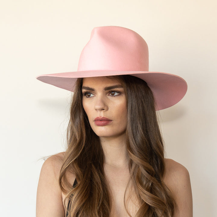 Khia Tullae The Lex pink wool wide-brim fedora, angled front view on model